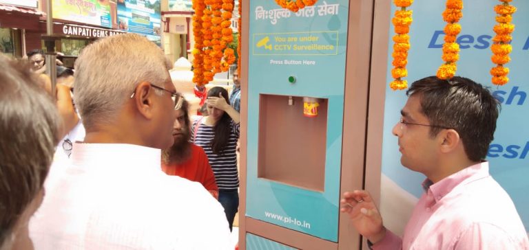 Ribbon-cutting ceremony marking the inauguration of a Pi-lo Smart Water ATM at a public location.
